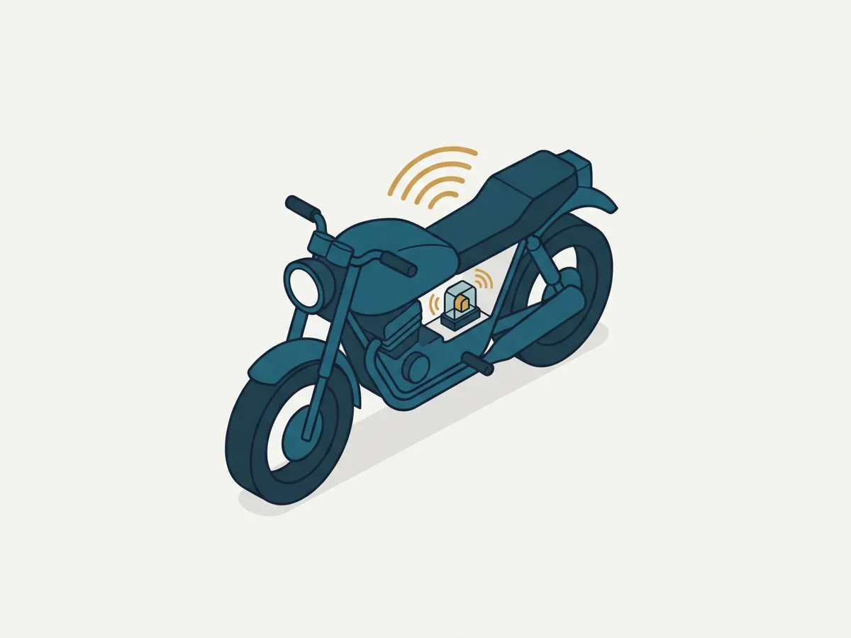 Kleines Alarmmodul unter der Sitzbank eines Motorrads, daneben ein Smartphone mit Alarmmeldung